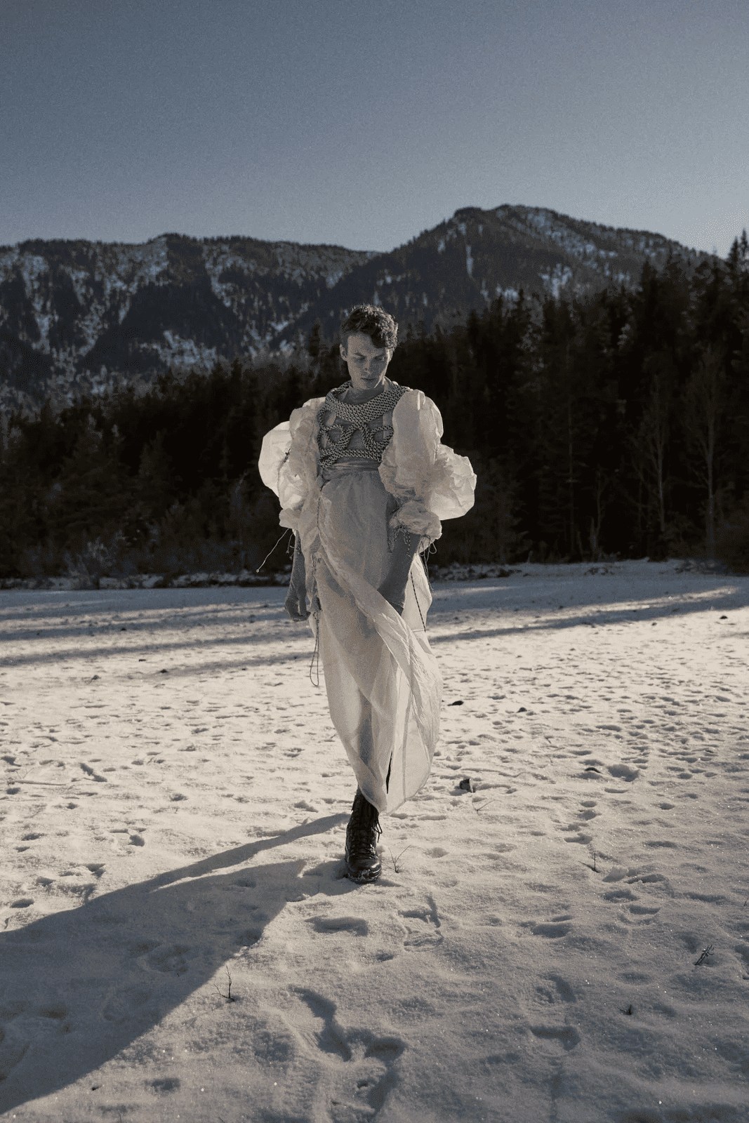 Male model with white outfit and and artistic green rope