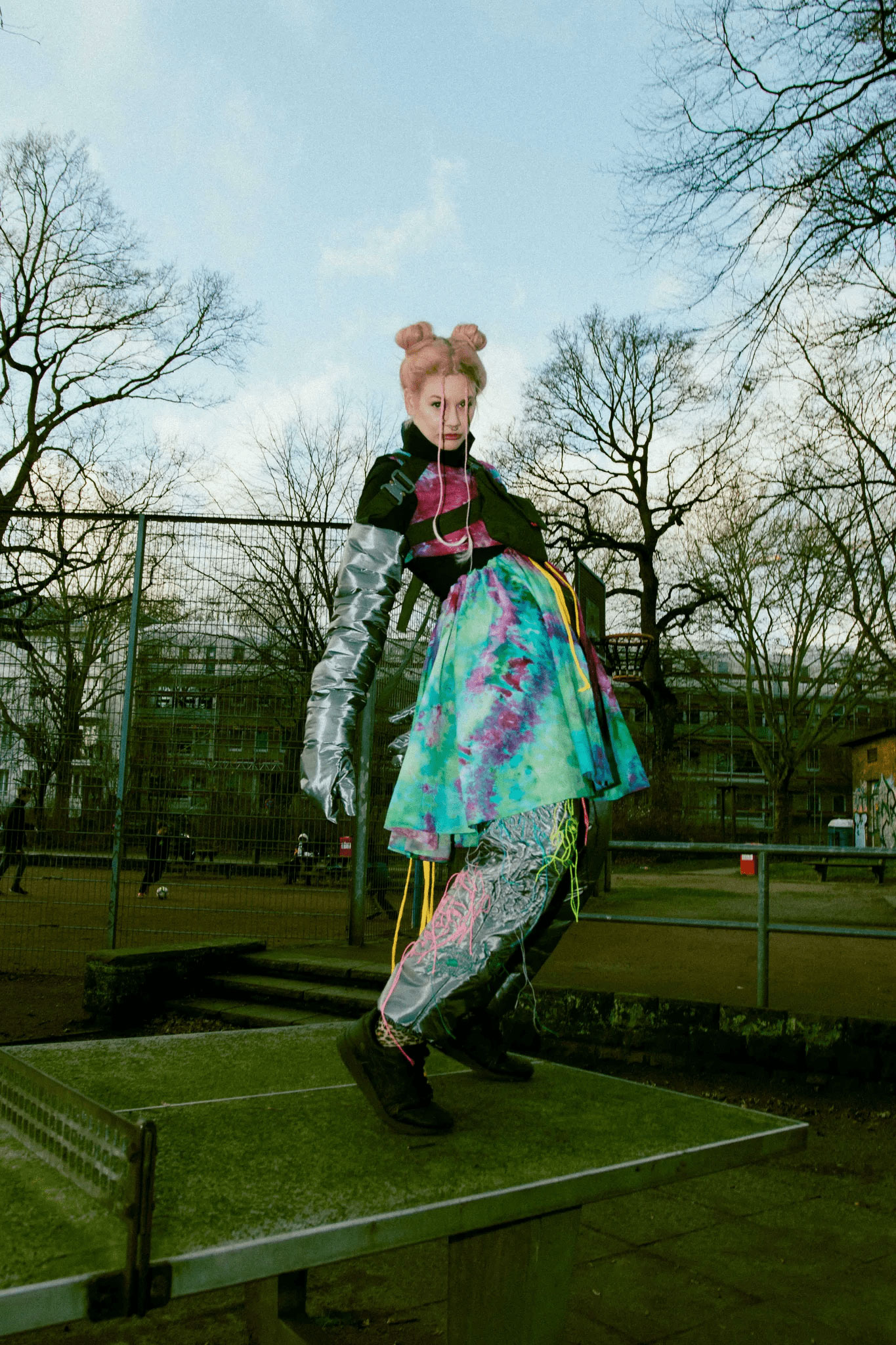 Female Model with artistic colorful outfit on a ping pong table