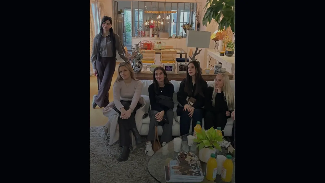 A group of amd sudents sitting together in a stylish living room with modern decor.